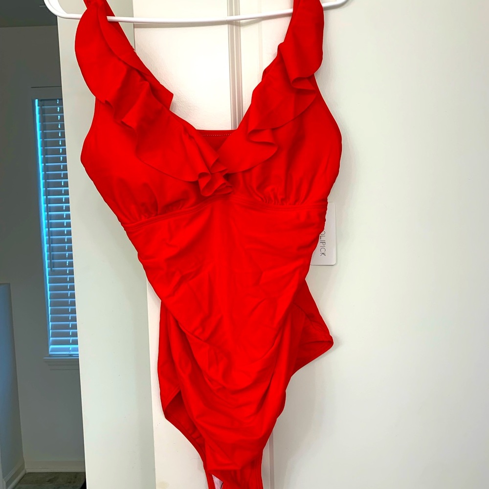 One piece red with ruffles swim suit. Brand new with tag